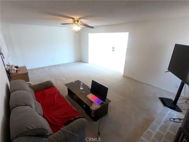 living room featuring ceiling fan and carpet