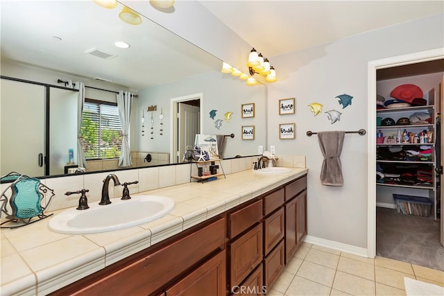 bathroom featuring vanity, walk in shower, and tile patterned floors