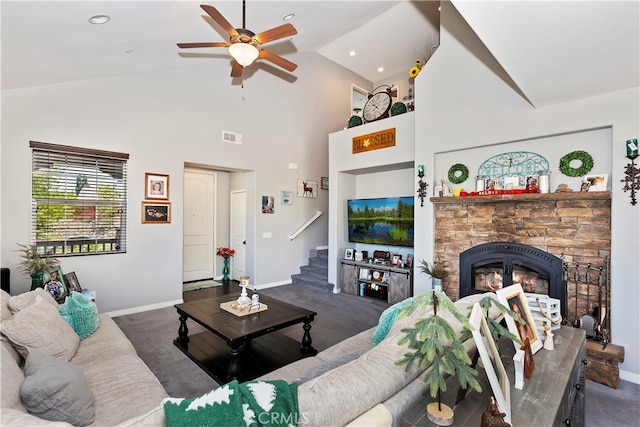 carpeted living room with ceiling fan, high vaulted ceiling, and a fireplace