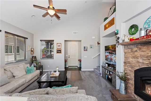 living room featuring ceiling fan, high vaulted ceiling, dark colored carpet, and a fireplace