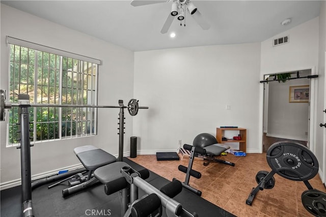 exercise area with ceiling fan and light tile patterned floors