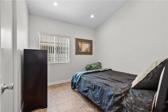 tiled bedroom with lofted ceiling