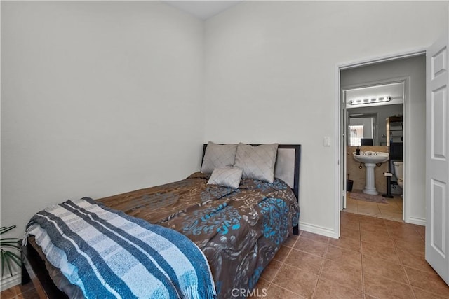 bedroom with tile patterned floors and ensuite bathroom