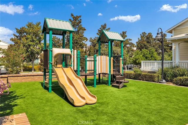 view of play area featuring a lawn