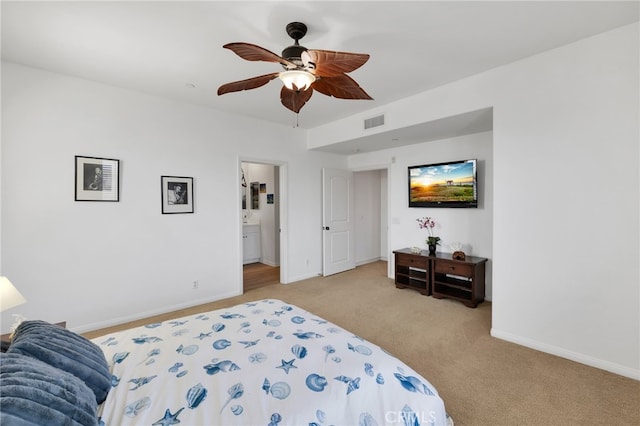 bedroom featuring connected bathroom, ceiling fan, and light colored carpet