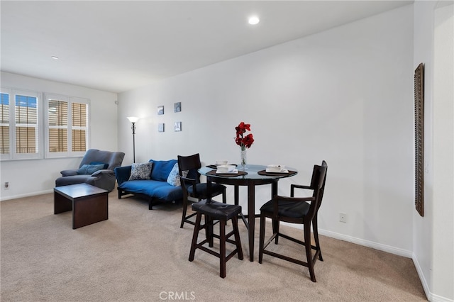 dining room featuring light carpet