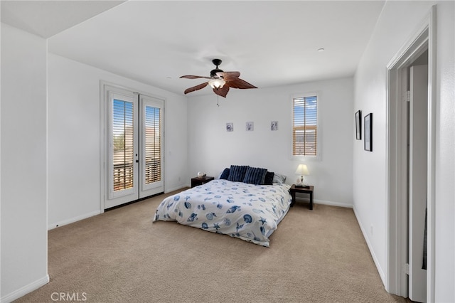 carpeted bedroom featuring access to outside, ceiling fan, and french doors