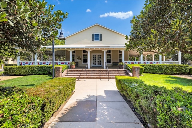 view of front of property with a front yard and covered porch