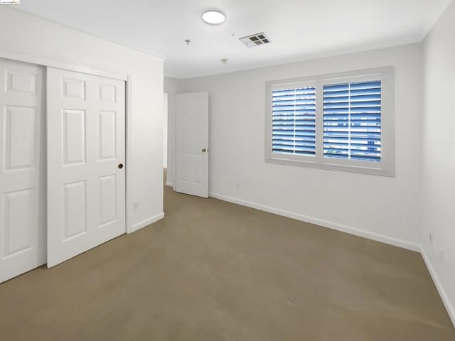 unfurnished bedroom with a closet and carpet