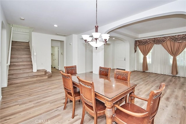 dining room featuring an inviting chandelier and light hardwood / wood-style flooring