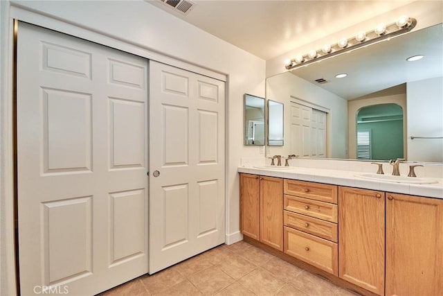 bathroom featuring tile patterned flooring and vanity