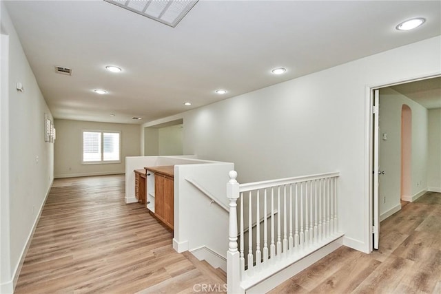 corridor with light hardwood / wood-style floors