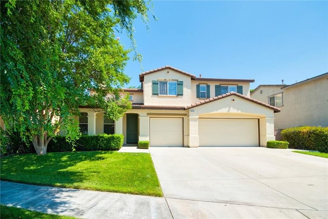 mediterranean / spanish home featuring a garage and a front lawn