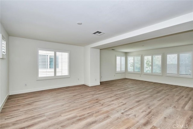 empty room featuring light hardwood / wood-style flooring and a healthy amount of sunlight