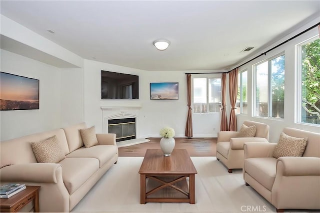 living room featuring light wood-type flooring and a wealth of natural light