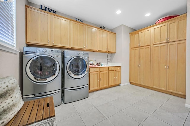 laundry room with cabinets, independent washer and dryer, light tile patterned flooring, and sink