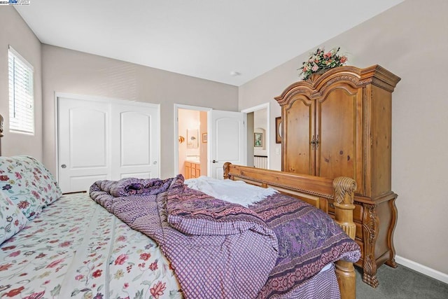 bedroom with a closet, ensuite bathroom, and carpet