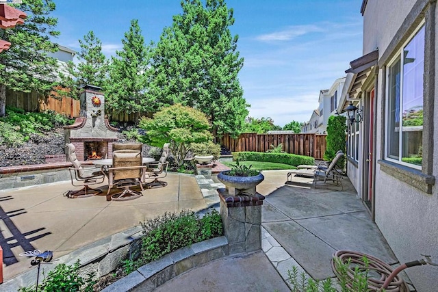 view of patio with an outdoor stone fireplace