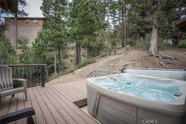 wooden deck featuring a hot tub