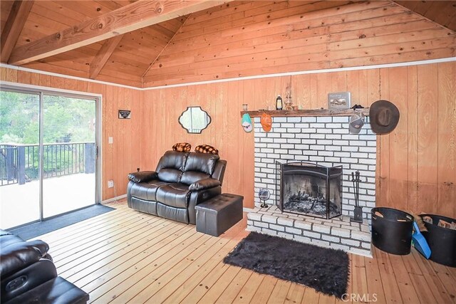 living room with light hardwood / wood-style flooring, vaulted ceiling with beams, and wooden walls