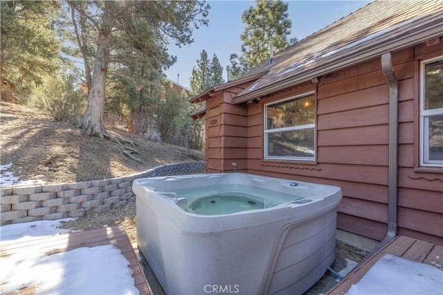 exterior details with gutters, a downspout, and a jacuzzi