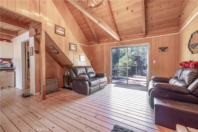 living room featuring vaulted ceiling with beams, wood walls, wood ceiling, and light wood-style floors