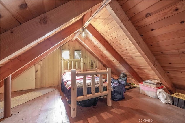 bedroom featuring light wood-type flooring, vaulted ceiling with beams, and wood ceiling