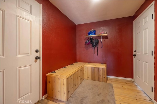 entryway featuring baseboards and light wood-style floors