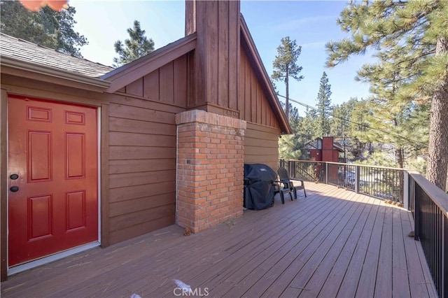 wooden deck with a grill