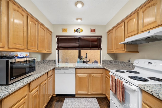 kitchen featuring light stone counters, sink, white appliances, dark hardwood / wood-style floors, and range hood