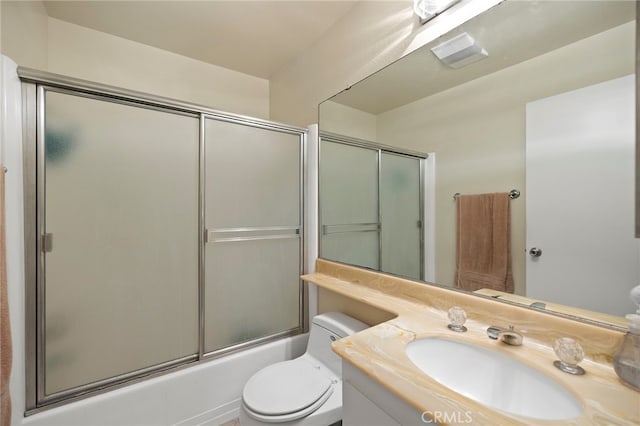 full bathroom with shower / bath combination with glass door, vanity, and toilet