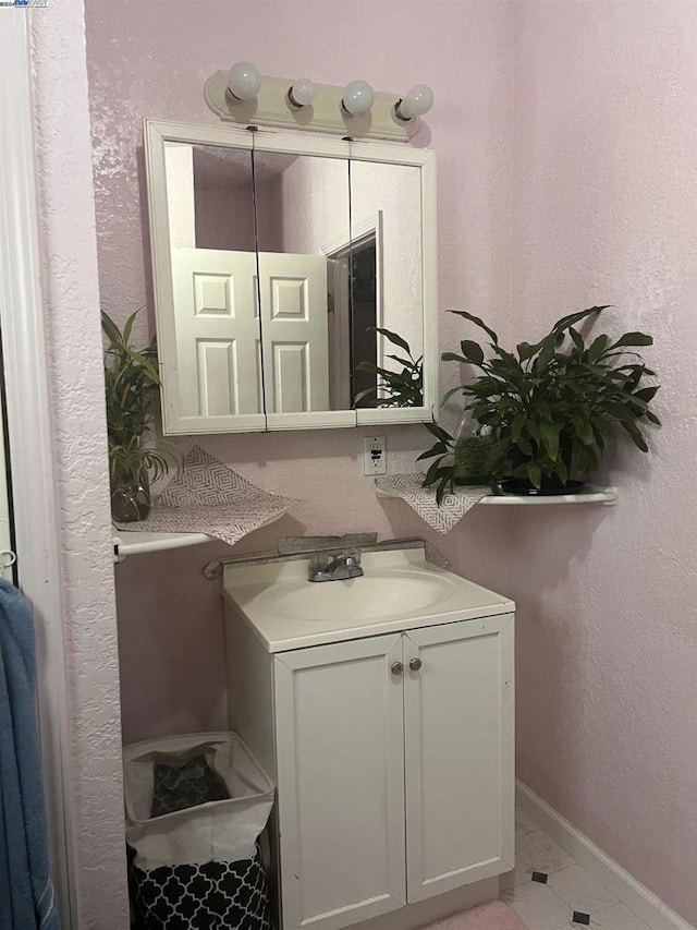 bathroom featuring tile patterned floors and vanity