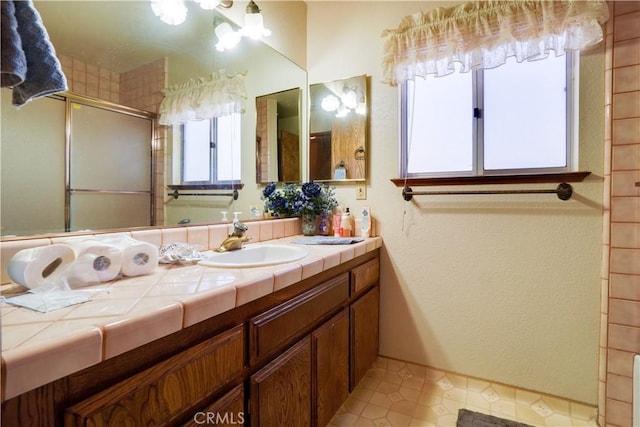 bathroom with vanity and a stall shower