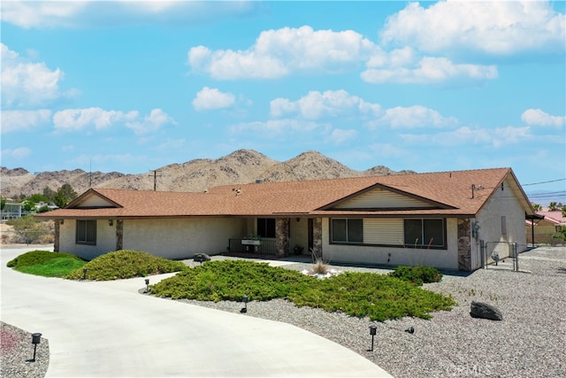 single story home featuring a gate, fence, and a mountain view