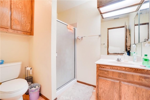 bathroom with vanity, toilet, and a stall shower