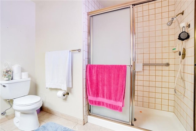 full bath with baseboards, tile patterned flooring, a shower stall, and toilet