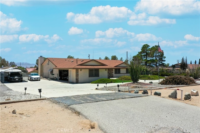 ranch-style home with driveway and a garage