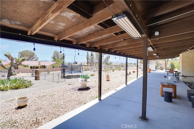 view of patio / terrace featuring a fenced backyard and a trampoline