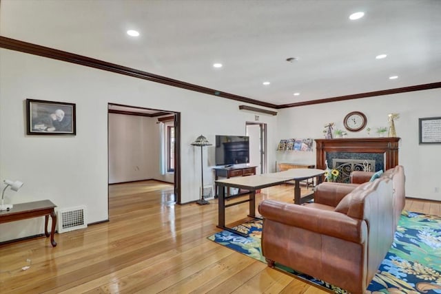 living room featuring light hardwood / wood-style floors and ornamental molding