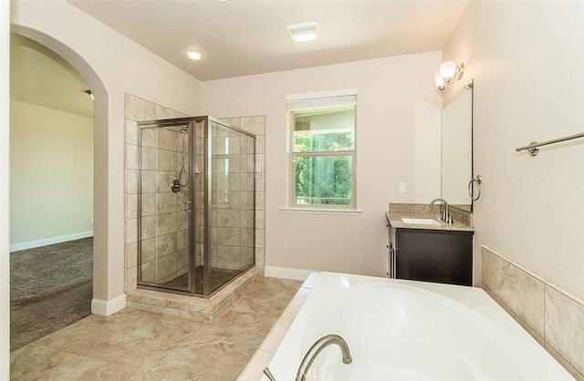 bathroom featuring vanity and separate shower and tub