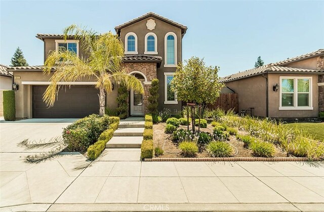 mediterranean / spanish house featuring a garage