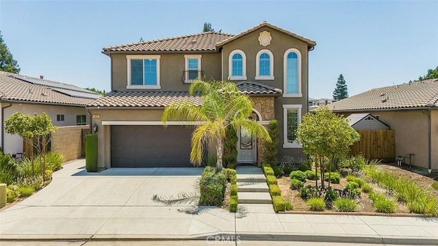 mediterranean / spanish house with a garage