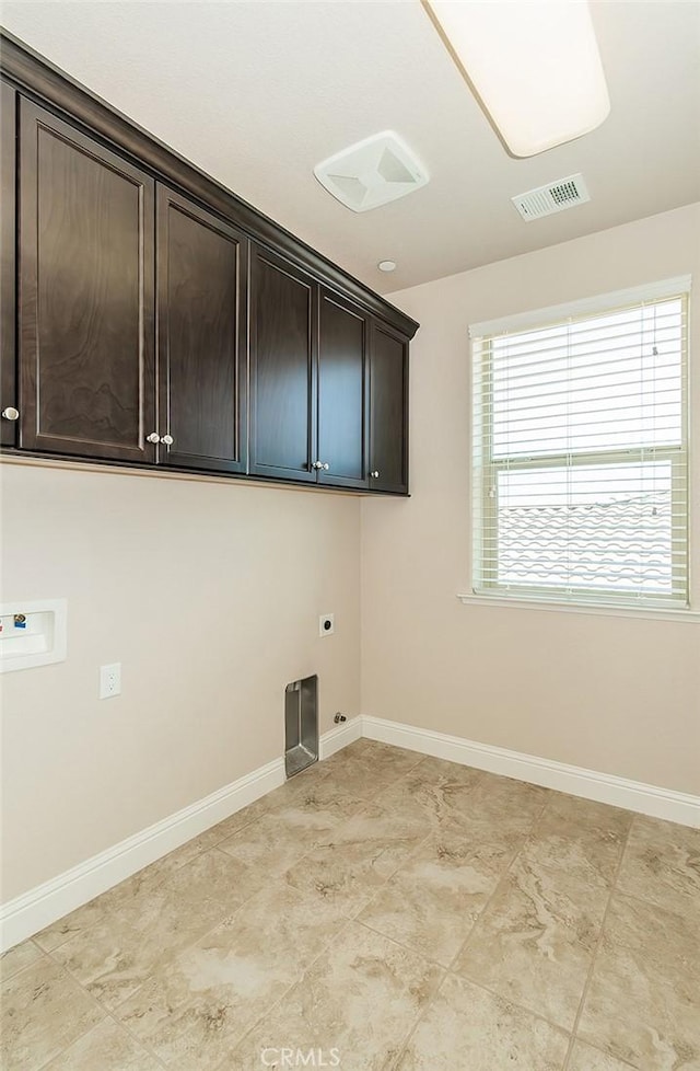 laundry room featuring cabinets, washer hookup, and electric dryer hookup