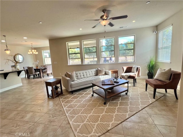 living room with ceiling fan with notable chandelier and light tile patterned flooring