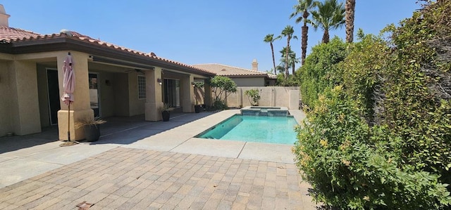 view of pool featuring an in ground hot tub, a patio, and ceiling fan