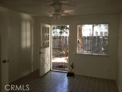 doorway featuring ceiling fan