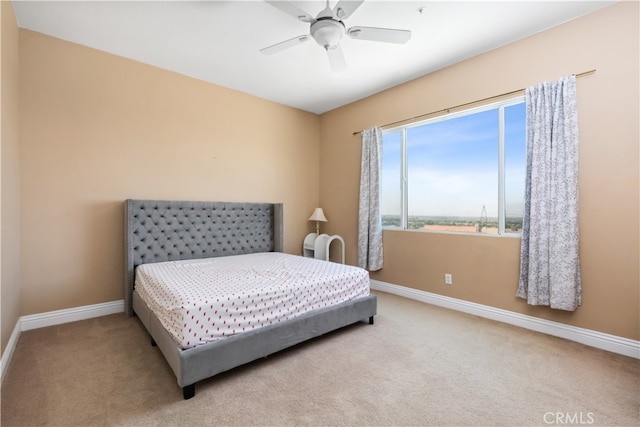 bedroom featuring light carpet and ceiling fan