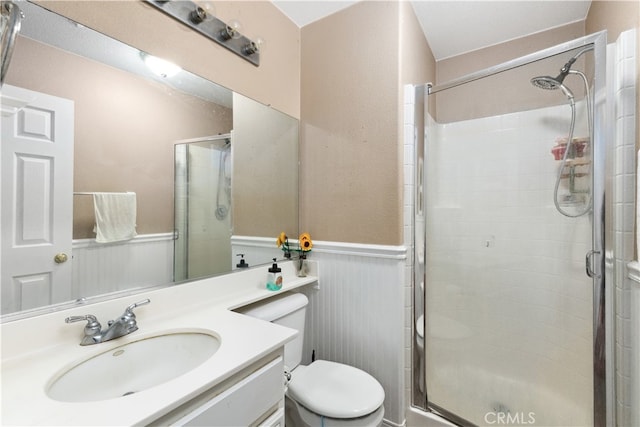 bathroom with vanity, an enclosed shower, and toilet