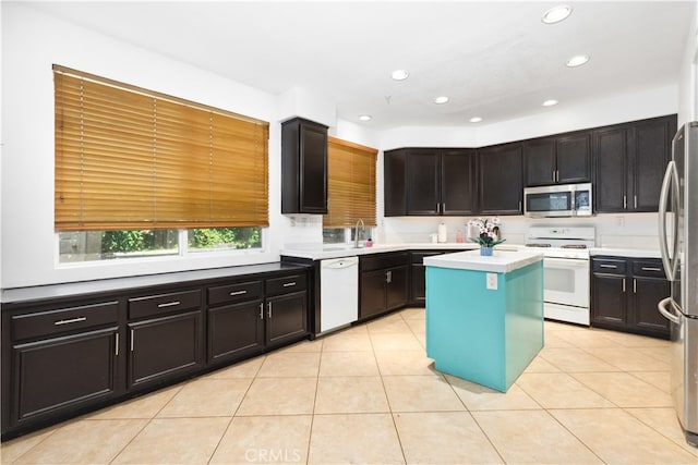 kitchen with stainless steel appliances, a center island, and light tile patterned floors