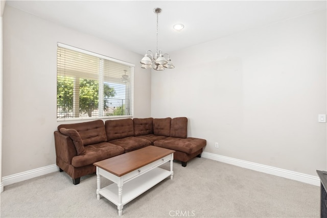 carpeted living room with an inviting chandelier